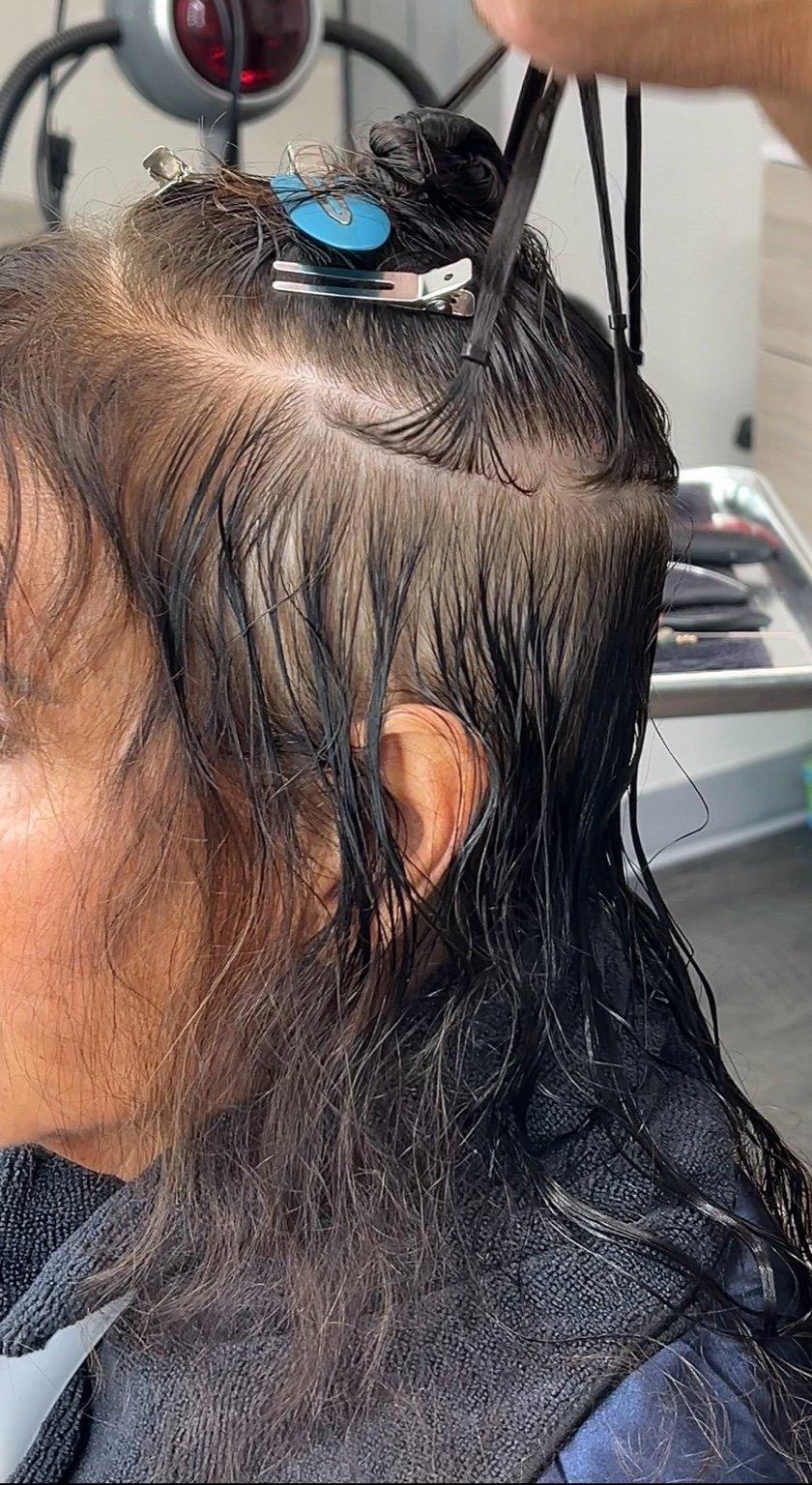 Scalp-safe hair extension installation showing clean sectioning with no tension spots on clients scalp by luxury hairstylist Davefunseeka in Phoenix, Arizona
